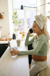 Future mother smiling on the phone that was successful with her IVF treatment