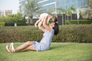 mother playing with kid in a park