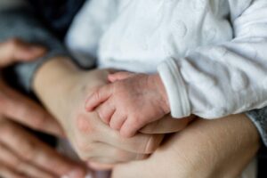 family hand with new born baby