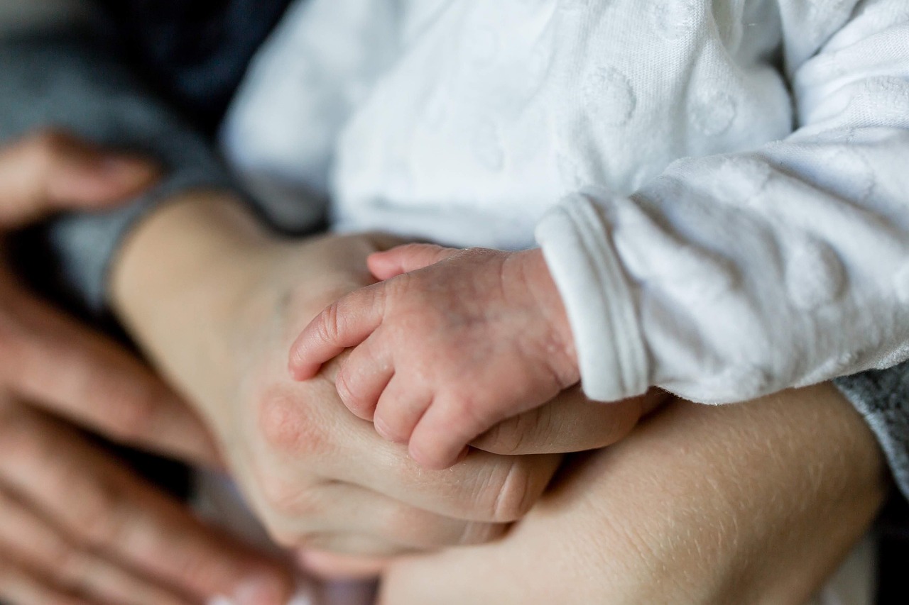 family hand with new born baby