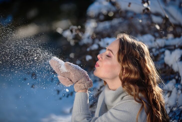 girl blowing snow