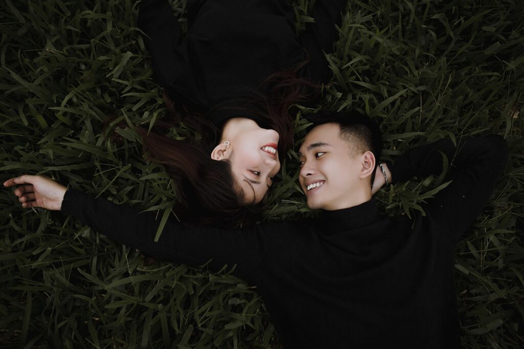 couple lying on grass
