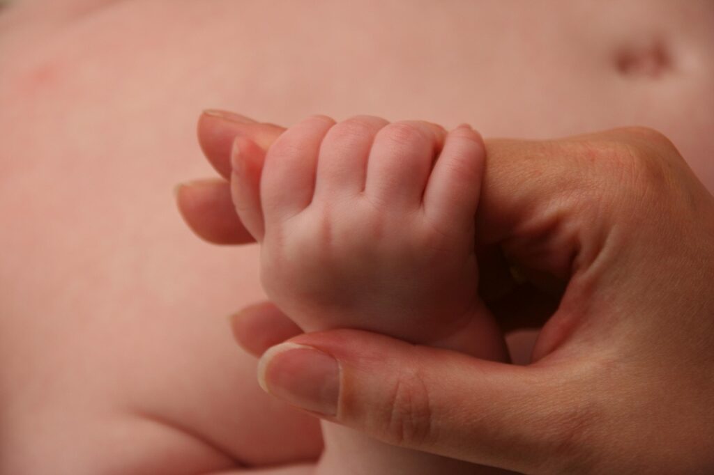 Baby hand holding