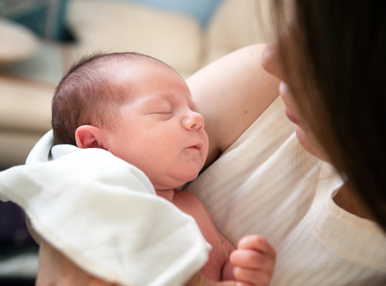 mom holding newborn in hands 