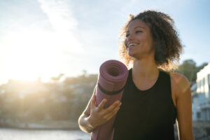 Woman holding yoga mat